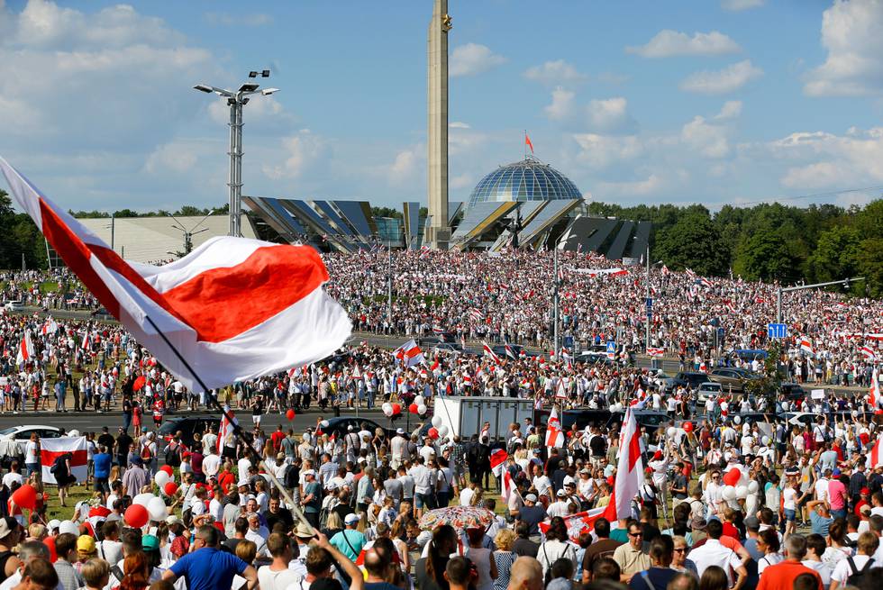 Belarusian opposition supporters rally in the center of Minsk, Belarus, Sunday, Aug. 16, 2020. Opposition supporters whose protests have convulsed the country for a week aim to hold a major march in the capital of Belarus. Protests began late on Aug. 9 at the closing of presidential elections. (AP Photo/Sergei Grits)