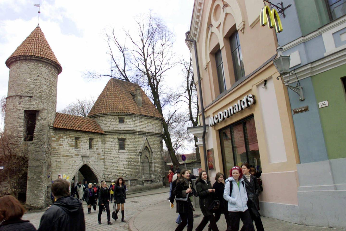 
ADVANCE FOR SUNDAY, AUG. 26--FILE--People pass a McDonalds tucked behind a medieval stone wall in Tallinn's old city, in this April 20, 2001 file photo. While many of the other 12 former Soviet states have floundered and have even elected former communists back into office, the Baltics have faced resolutely to the West and have brought an impossible dream within reach: The prospect of membership in NATO and the prosperous, borderless European Union. (AP Photo/Peeter Langovits, Postimees, File)