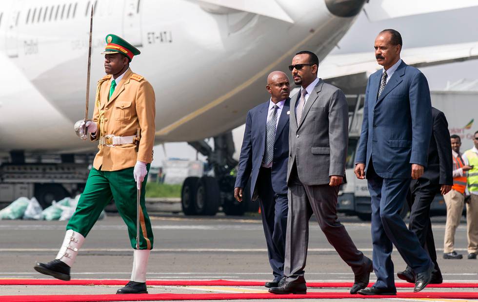 FILE - In this Saturday, July 14, 2018 file photo, Eritrea's President Isaias Afwerki, right, is welcomed by Ethiopia's Prime Minister Abiy Ahmed, 2nd right, for his first visit in 22 years, at the airport in Addis Ababa, Ethiopia. Celebrating their dramatic diplomatic thaw, the leaders of Ethiopia and Eritrea on Tuesday, Sept. 11, 2018 marked the Ethiopian new year at a border where a bloody war and ensuing tensions had divided them for decades. (AP Photo/Mulugeta Ayene, File)