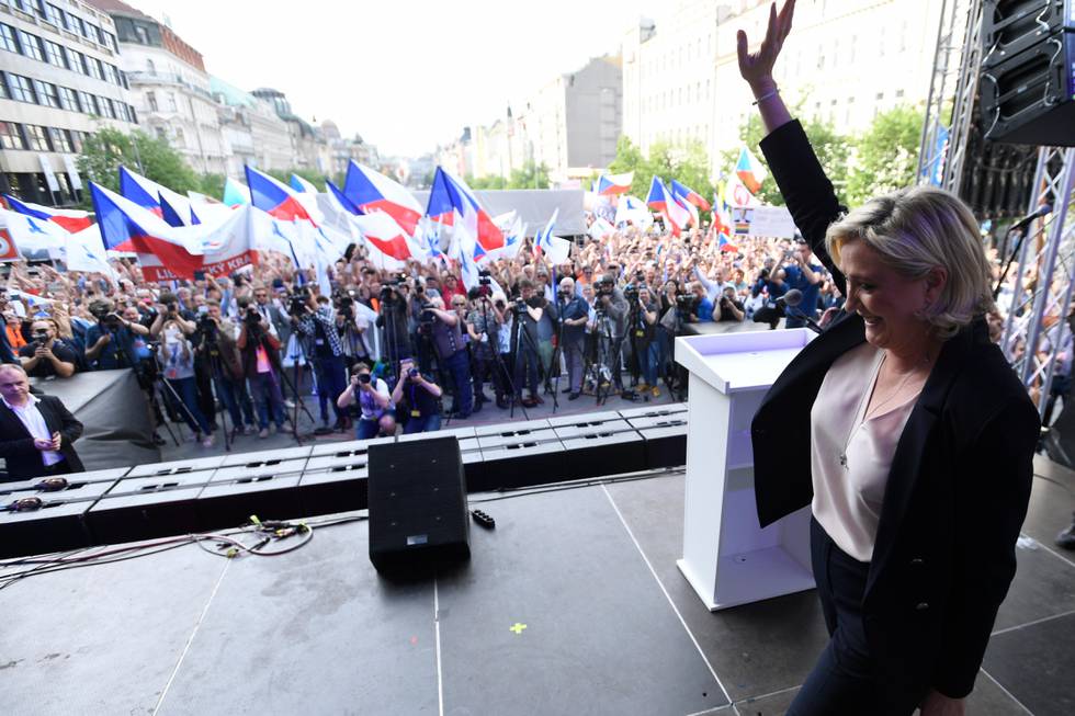 Leader of the French National Front Marine Le Pen waves as she arrives on stage during the rally against "dictate of the European Union" organized by Czech far-right Freedom and Direct Democracy party (SPD) in Prague, Czech Republic, Thursday, April 25, 2019. (Michal Kamaryt/CTK via AP)