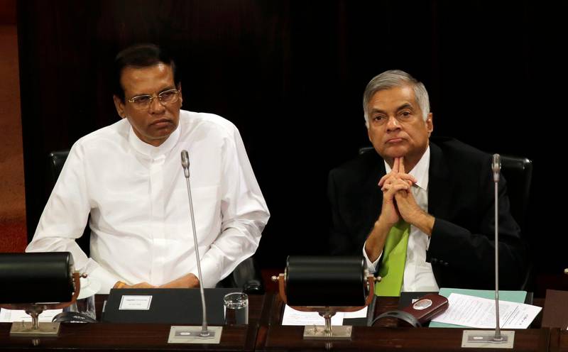 FILE- In this Oct. 3, 2017, file photo, Sri Lankan President Maithripala Sirisena, left, and Prime Minister Ranil Wickremesinghe attend a special session held to mark the country's seventieth anniversary of the first parliament of democracy, in Colombo, Sri Lanka. Sirisena has kept his countryÄôs internal political rift from spilling over to a UN human rights council meeting this week by abandoning plans to oppose his prime ministerÄôs decision to co-sponsor a resolution that would give the island nation more time to address war crime allegations stemming from its long civil war. The co-resolution to be adopted on March 21, 2019 would give Sri Lanka two more years to investigate and prosecute suspects of rights violations. (AP Photo/Eranga Jayawardena, File)