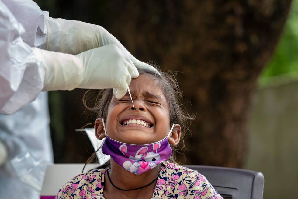 An Indian girl cries as a medical worker collect her swab sample for COVID-19 test at a rural health center in Bagli, outskirts of Dharmsala, India, Monday, Sept. 7, 2020. India's coronavirus cases are now the second-highest in the world and only behind the United States. (AP Photo/Ashwini Bhatia)