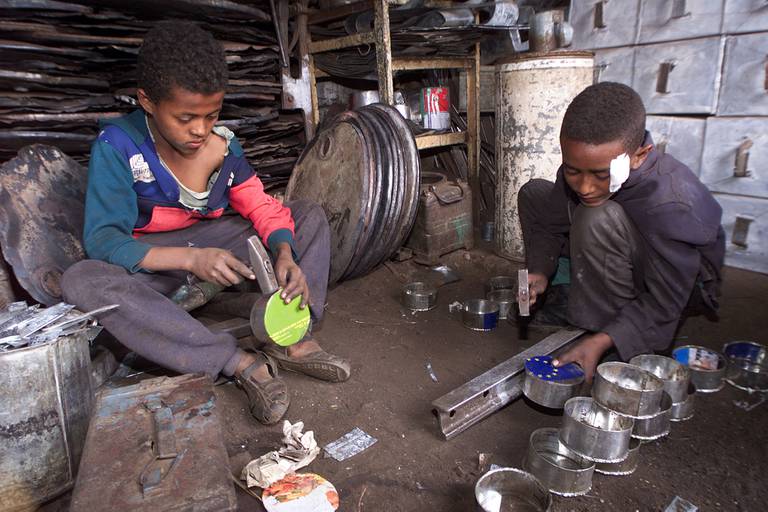 Children work at making containers at a metal recycling shop in Asmara, Eritrea Saturday, June 3, 2000. Workers in Asmara recycle virtually everything, but the two-year war with Ethiopia is threatening to erode Eritrea's fabled self reliance. (AP Photo/Jean-Marc Bouju)