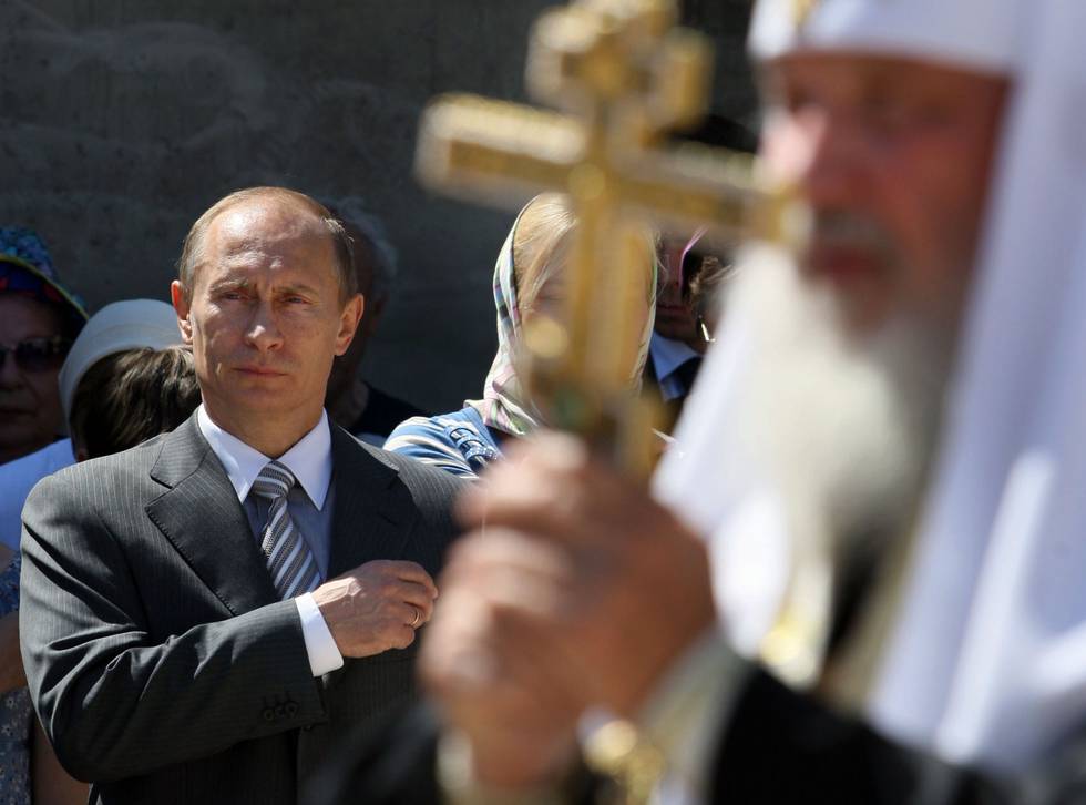 Russian Prime Minister Vladimir Putin, left, reacts, as he attends a foundation stone laying ceremony of a church complex in the village of Usovo outside Moscow, Saturday, May 30, 2009. At right is Russian Orthodox Patriarch Kirill. (AP Photo/Alexei Druzhinin, Pool)