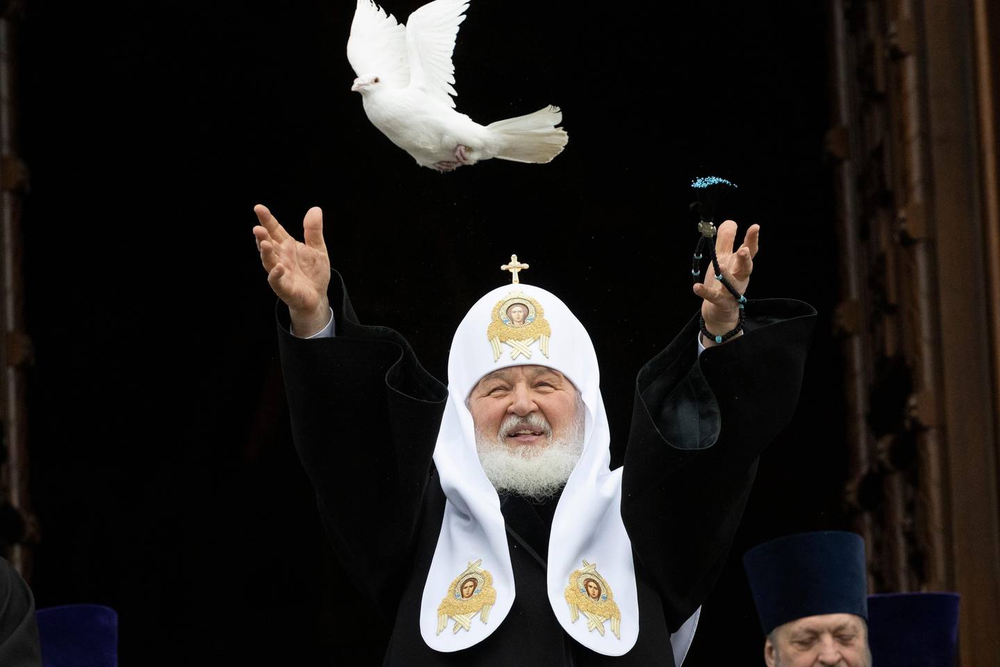Russian Orthodox Church Patriarch Kirill releases a bird celebrating the Annunciatio on the eve of Orthodox Easter during a live broadcast outside the almost empty Christ the Savior Cathedral in Moscow, Russia, Tuesday, April 7, 2020. As the coronavirus outbreak picked up speed in Russia, authorities all over the country cancelled public events and ordered residents in most regions to stay home, with the exception of grocery shopping, going to pharmacies or taking out trash. Eastern Orthodox churches, which observe the ancient Julian calendar, usually celebrate Easter later than Western churches. (AP Photo/Alexander Zemlianichenko)