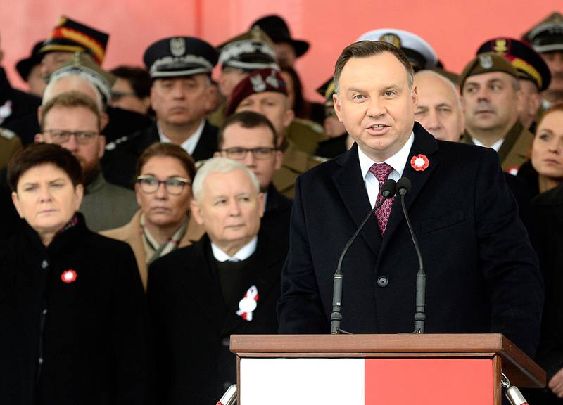 Polish President Andrzej Duda, right, speaks during the official ceremony marking Poland's Independence Day, in Warsaw, Poland, Sunday, Nov. 11, 2018, as leader of the ruling Law and Justice party, Jaroslaw Kaczynski, second left, stands behind. The Independence Day in Poland celebrates the nation regaining its sovereignty at the end of World War I after being wiped off the map for more than a century. (AP Photo/Alik Keplicz)