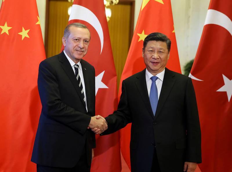 China's President Xi Jinping, right, shakes hands with Turkey's President Recep Tayyip Erdogan prior to their meeting in Beijing, Saturday, May 13, 2017. (Press Presidency Press Service via AP, Pool)
