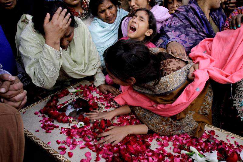 FILE - In this Monday, March 16, 2015 file photo, family members of Pakistani Christian community mourn the death of a victim of Sunday's suicide bombings that struck two churches, in Lahore, Pakistan. Pakistan's minority Christians blocked roads Monday in protest over the bombings killing more than a dozen people in the latest attack against religious minorities in this increasingly fractured country. (AP Photo/K.M. Chaudary, File)