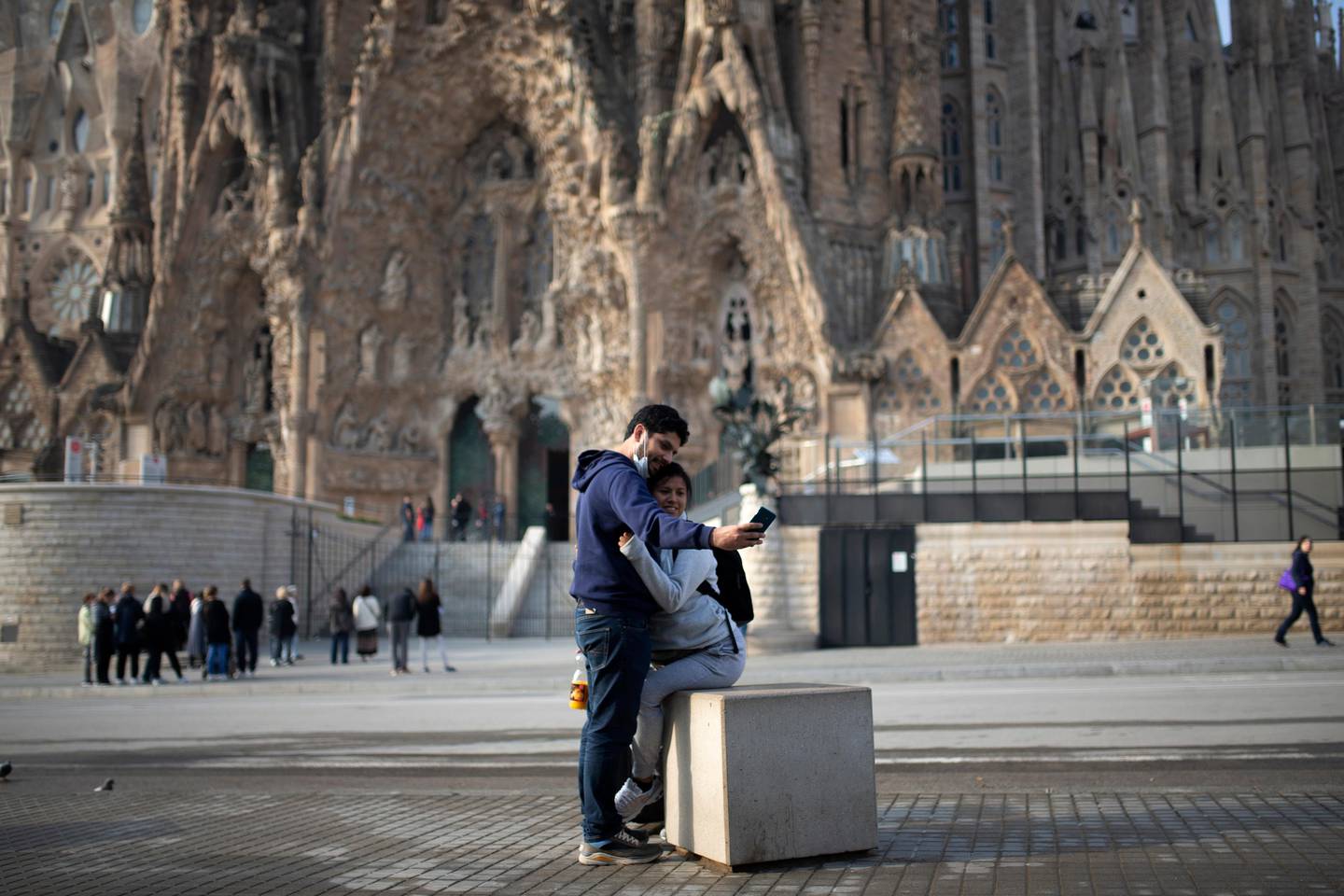 People take a selfie outside the Sagrada Familia basilica in Barcelona, Spain, Friday, March 13, 2020. The basilica closed its doors to visitors and suspend construction from Friday, March 13 to prevent the spread of the new COVID-19 coronavirus. Spain, along with Italy and France, is among the countries worst hit by the virus so far in Europe. For most people, the new coronavirus causes only mild or moderate symptoms. For some it can cause more severe illness. (AP Photo/Joan Mateu)
