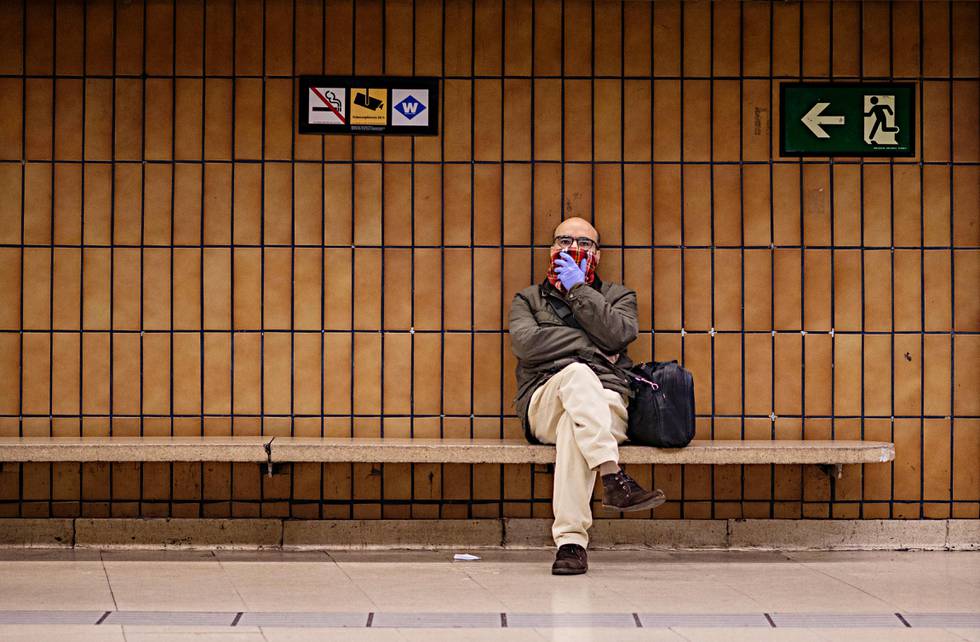 A man covers his mouth and nose as he waits at the train station in Barcelona, Spain, Tuesday, March 17, 2020. Police checked passports and IDs at the Pyrenees' border with France and along the 1,200 kilometer shared border with Portugal, as Spain re-established controls for incoming and outgoing travelers to stem the new coronavirus outbreak. For most people, the new coronavirus causes only mild or moderate symptoms. For some, it can cause more severe illness, especially in older adults and people with existing health problems. (AP Photo/Emilio Morenatti)