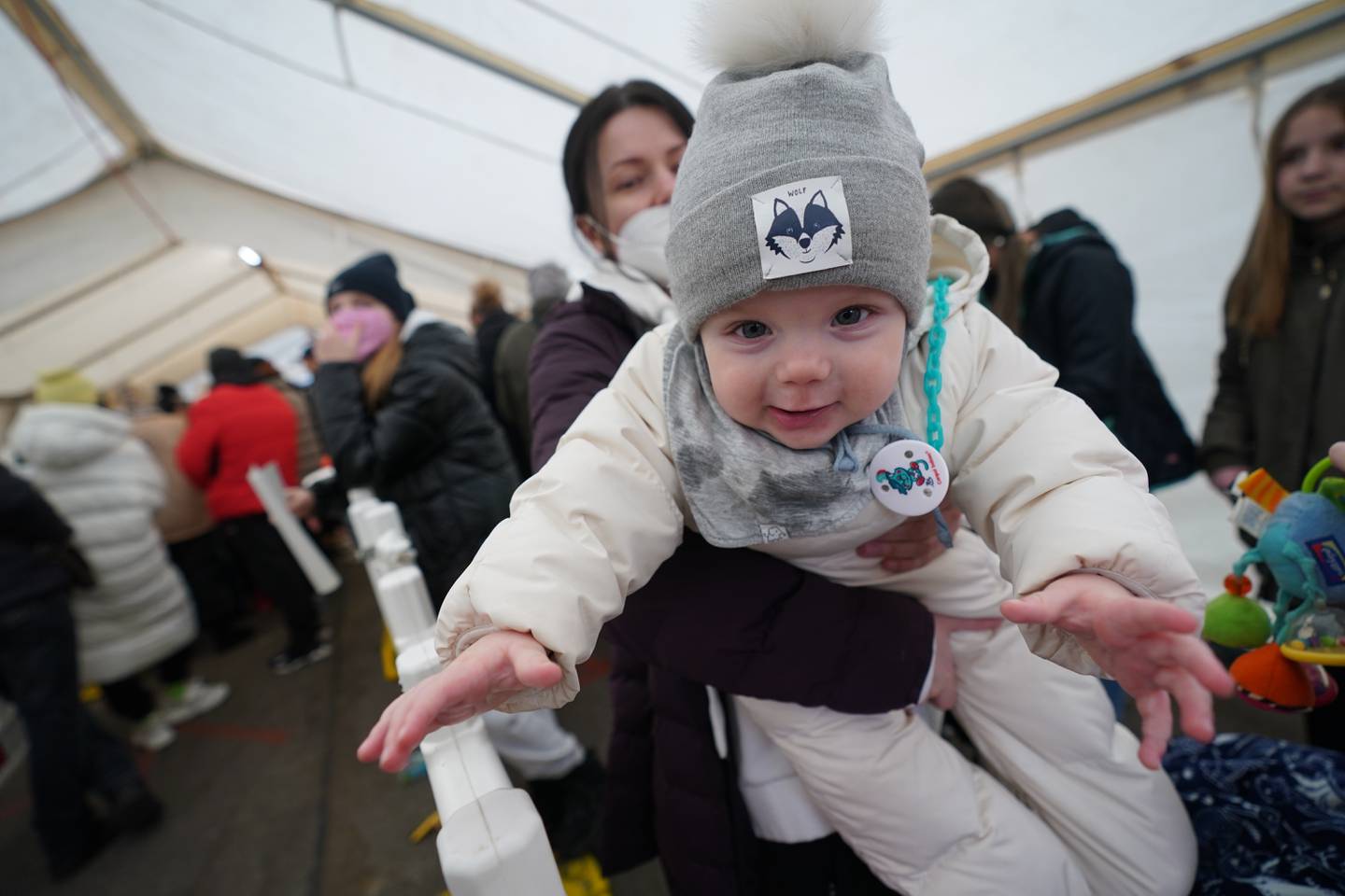 Liliia from Ternopil in Ukraine carries her eight-month-old son Paul in her arms as she waits at the registration office for refugees inn Hamburg, Germany, Monday, March 14, 2022. Germany's Interior Ministry said Monday that it has so far registered 146,998 refugees from Ukraine coming to the country, but the real number may differ if people didn't register or moved on to another country. (Marcus Brandt/dpa via AP)