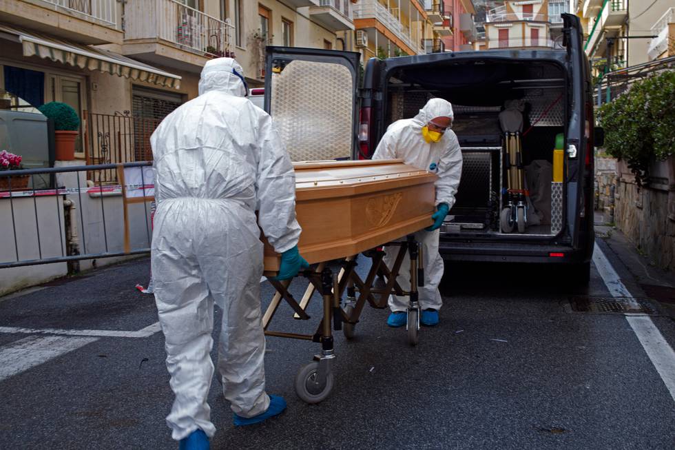 Medical staff wearing protective suits carry the coffin containing the body of Assunta Pastore, 87, after she passed away in her room at the Garden hotel in Laigueglia, northwest Italy, Liguria region, Sunday March 1, 2020. The woman, part of a group of elderly tourist from the Lombardia region, tested positive of the COVID-19. The hotel has been placed under quarantine as Italy continued to scramble Sunday to contain the spread of the corona virus. (AP Photo)