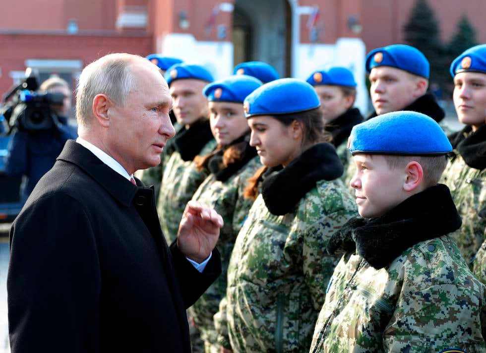 Russian President Vladimir Putin talks with members of Yunarmia (Young Army), an organization sponsored by the Russian military that aims to encourage patriotism among the Russian youth, at the monument to Kuzma Minin and Dmitry Pozharsky, the leaders of a struggle against foreign invaders in 1612, marking National Unity Day at Red Square in Moscow, Russia, Sunday, Nov. 4, 2018. (Mikhail Klimentyev, Sputnik, Kremlin Pool Photo via AP)