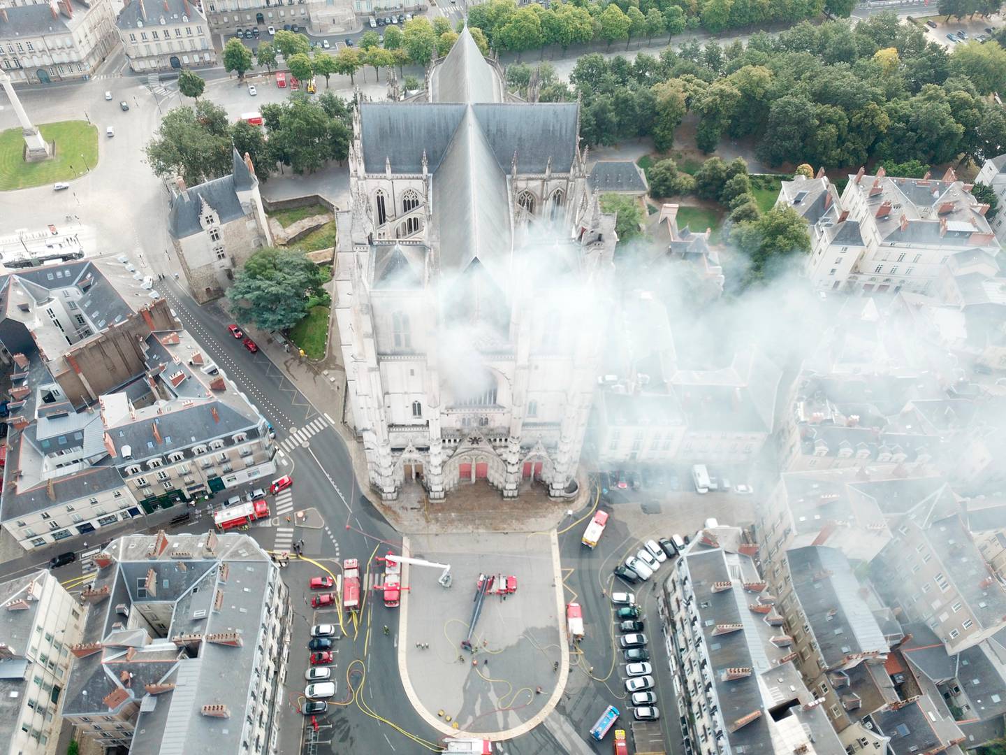 In this image provided by SDIS 44 Department of Fire and Rescue, fire fighters work to extinguish the blaze at the Gothic St. Peter and St. Paul Cathedral, in Nantes, western France, Saturday, July 18, 2020. French officials launched an arson inquiry Saturday after the fire broke out destroying the organ, shattered stained glass windows and sent black smoke spewing from between the cathedral towers. (SDIS 44 Department of Fire and Rescue via AP)
