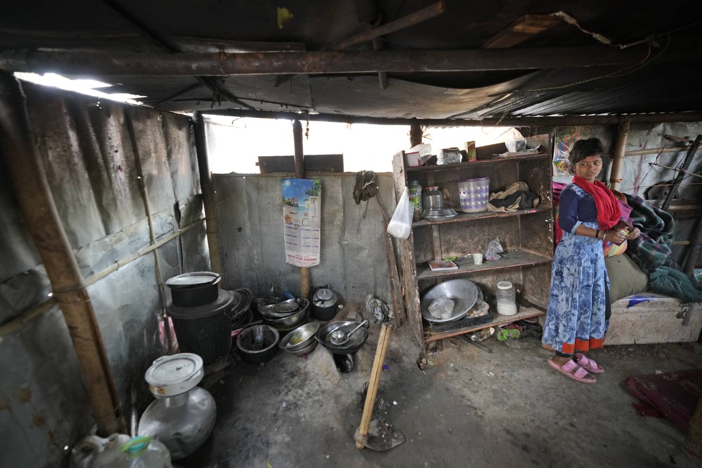 A girl stands in her shanty home on the outskirts of in Guwahati, India, Friday, Feb. 10, 2023. In India, the legal marriageable age is 21 for men and 18 for women. Poverty, lack of education, and social norms and practices, particularly in rural areas, are considered reasons for child marriages across the country. UNICEF estimates that at least 1.5 million girls under 18 get married in India every year, making it home to the largest number of child brides in the world, accounting for a third of the global total. (AP Photo/Anupam Nath)