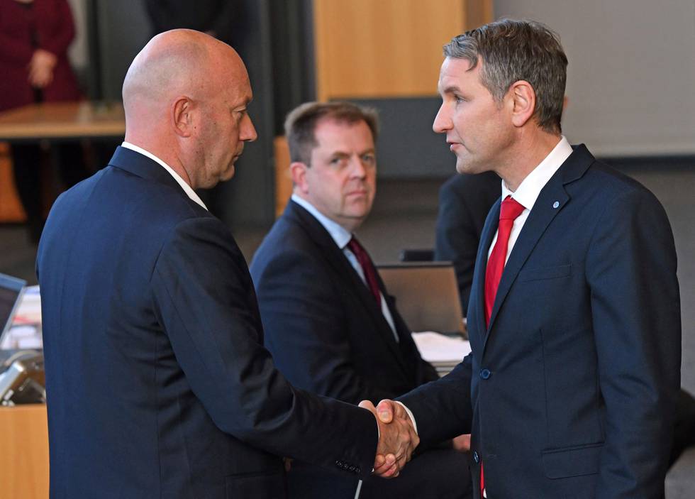 AfD parliamentary party leader Bjoern Hoecke, right, shakes hands with Thomas Kemmerich of the Free Democrats, in Erfurt, Germany, Wednesday, Feb. 5, 2020. Kemmerich, a pro-business politician, has been elected as the governor of the eastern German state of Thuringia in a surprise result after a far-right party threw its votes behind him. (Martin Schutt/dpa via AP)