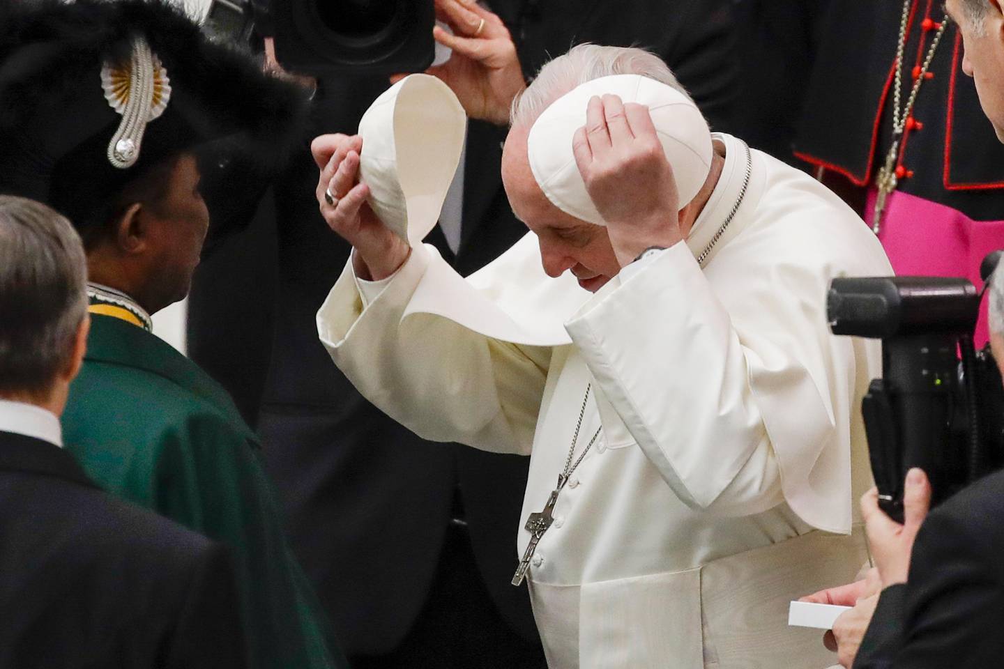 Pope Francis tries on a cap he was offere during his weekly general audience, in Paul VI Hall at the Vatican, Wednesday, Jan. 15, 2020. (AP Photo/Alessandra Tarantino)