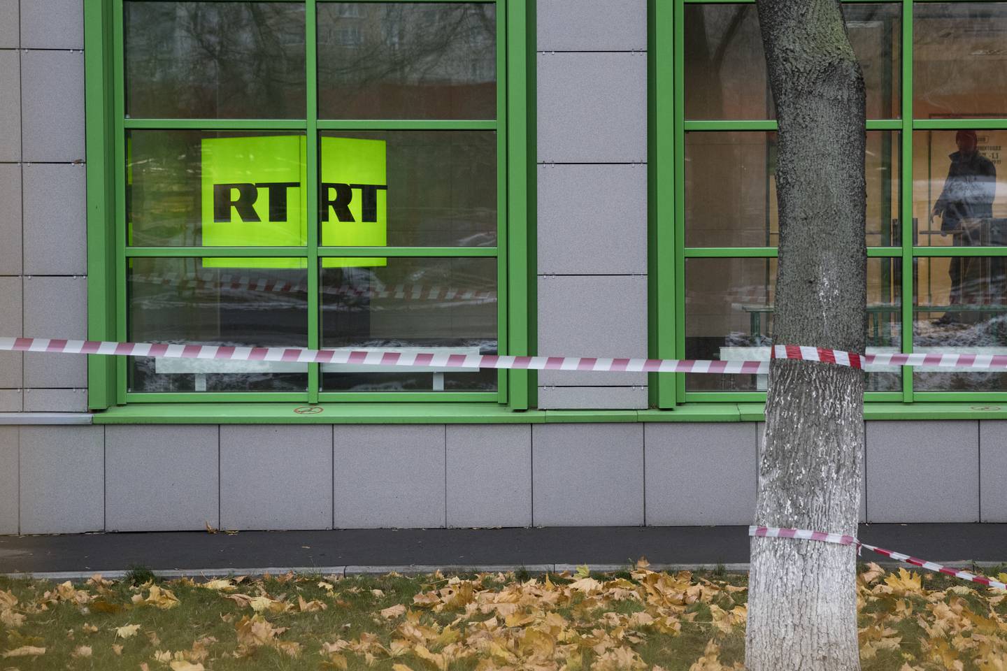 Russian state-owned television station RT logo is seen at the window of the company's office in Moscow, Russia, Friday, Oct. 27, 2017. Twitter said on Thursday it would ban ads from RT and Sputnik, two state-sponsored Russian news outlets that the U.S. intelligence community has said tried to interfere with the 2016 U.S. presidential election. (AP Photo/Pavel Golovkin)