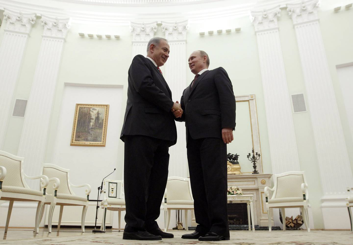 Russian President Vladimir Putin, right, shakes hands with Israeli Prime Minister Benjamin Netanyahu during their meeting in the Kremlin in Moscow, Russia, Wednesday, Nov. 20, 2013. Their talks are expected to focus on the Iranian nuclear program. Wednesday's talks in the Kremlin come as Iran and six world powers, including Russia, sat down for a new round of negotiations. Putin and Netanyahu didn't mention the Iranian issue in brief remarks at the meetings start before continuing the talks in private. (AP Photo/Maxim Shemetov)