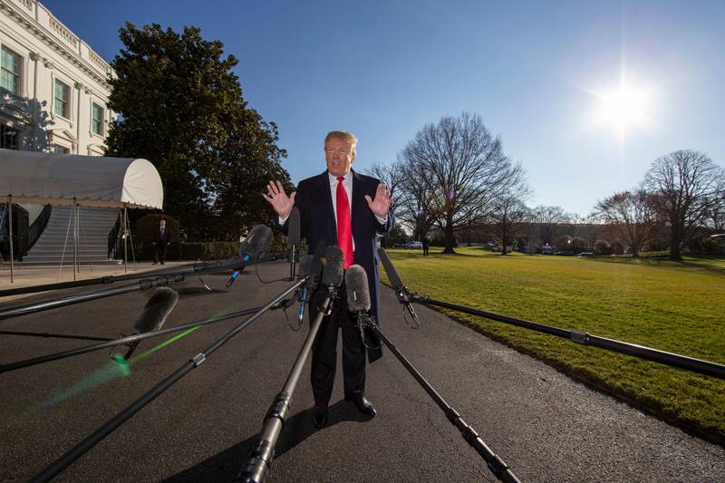 President Donald Trump speaks on the South Lawn of the White House as he walks to Marine One, Sunday, Jan. 6, 2019, in Washington. Trump is en route to Camp David. (AP Photo/Alex Brandon)