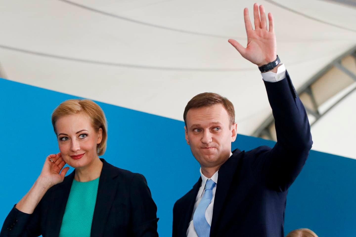 Russian opposition leader Alexei Navalny and his wife Yulia attend his supporters' meeting that nominated him for the presidential election race in Moscow, Russia, Sunday, Dec. 24, 2017. Nevertheless, the 41-year-old anti-corruption crusader has run a yearlong grass-roots campaign and staged waves of rallies to push the Kremlin to let him run. (AP Photo/Pavel Golovkin)