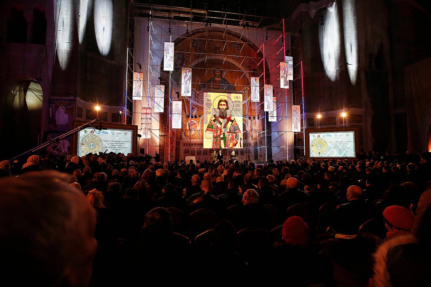 People attend a ceremony unveiling a new mosaic in the St. Sava Serbian Orthodox temple in downtown Belgrade, Serbia, Thursday, Feb. 22, 2018. Russian Foreign Minister Sergey Lavrov took part in the unveiling of new mosaic work from Russia depicting Jesus Christ inside of the St. Sava Temple, the largest Orthodox temple in Europe. (AP Photo/Darko Vojinovic)