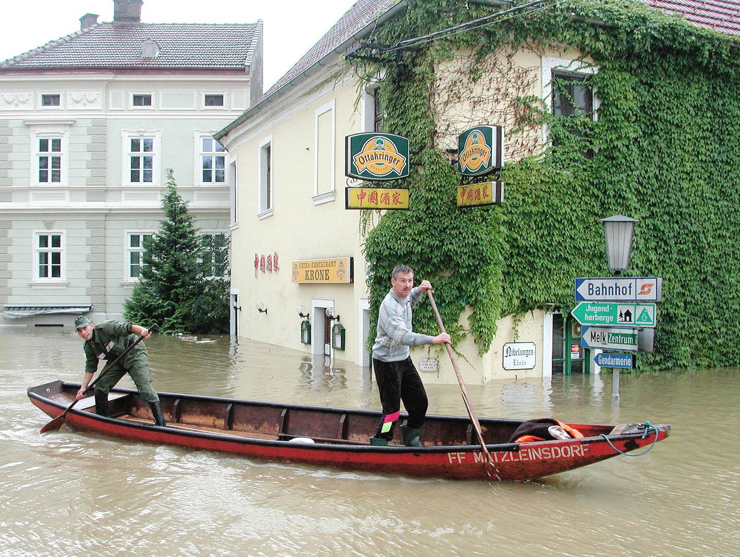 
Firefighters steer their boat past a flooded Chinese restaurant in the city of Melk in the Austrian province of Lower Austria, some 90 kilometers west of Vienna, which was flooded by Danube River on Tuesday, Aug. 13, 2002. (AP Photo/Paul Plutsch)