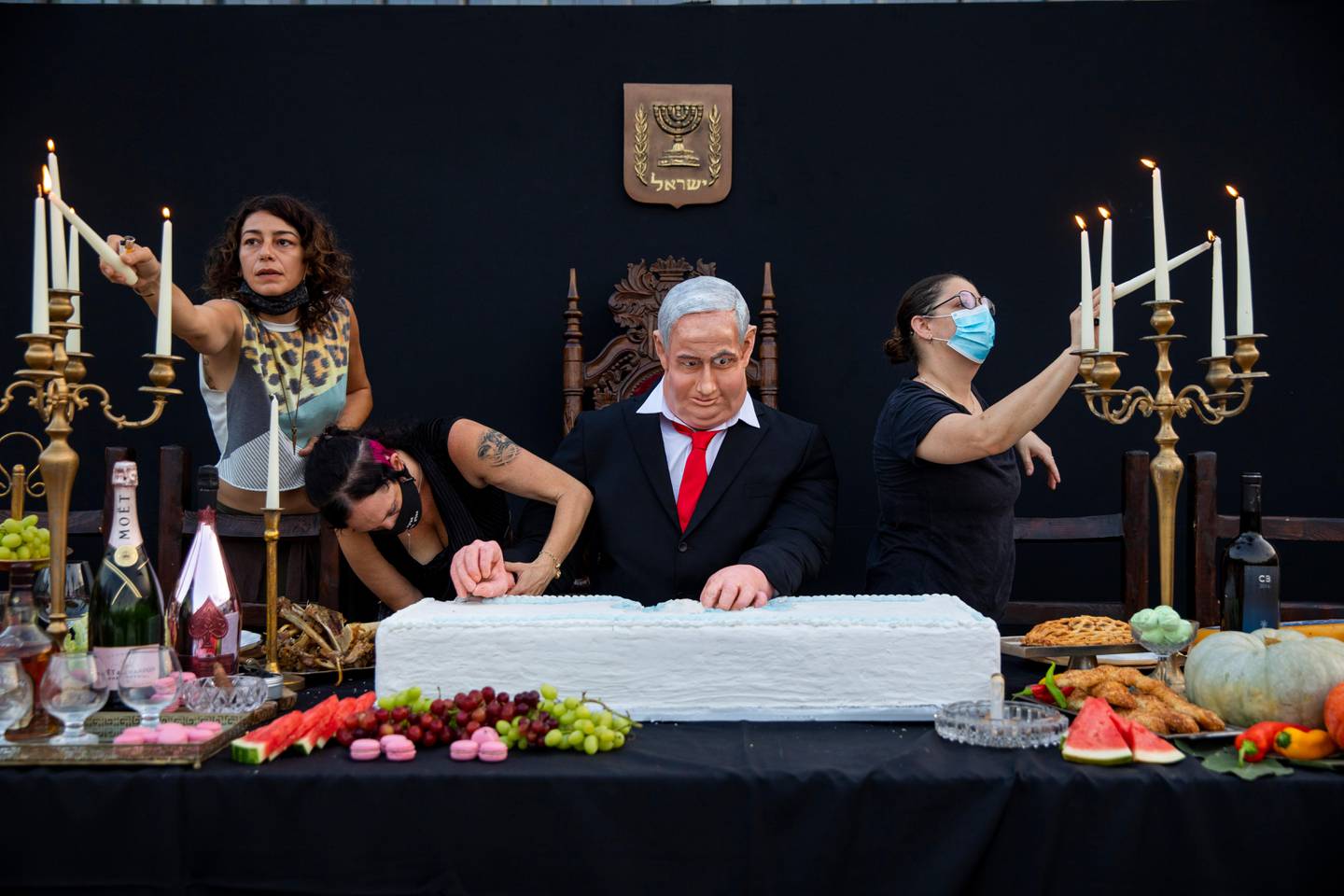 Team members of Israeli artist Itay Zalait, work on an installation depicting Prime Minister Benjamin Netanyahu at a mock "Last Supper" at Rabin square in Tel Aviv, Israel, Wednesday, July 29, 2020. The installation, placed in a central Tel Aviv square on Wednesday, in the latest twist in a summer of protests against Netanyahu and his lengthy rule. (AP Photo/Oded Balilty)