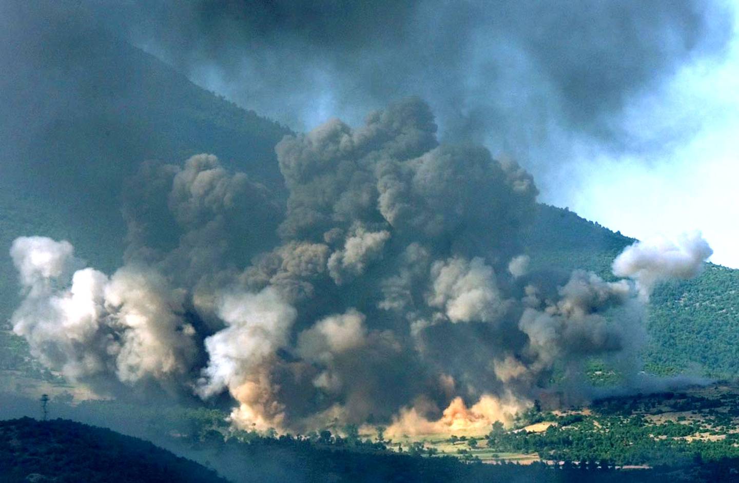 The Kosovo village of Gorozhubi comes under attack from U.S. B-52 bombers, Sunday June 6 1999. Fighting between Kosovo Liberation Army and Serb forces has been raging, as a peace plan for Kosovo is being discussed on the Kosovo-Macedonia border. (AP Photo/Jerome Delay)