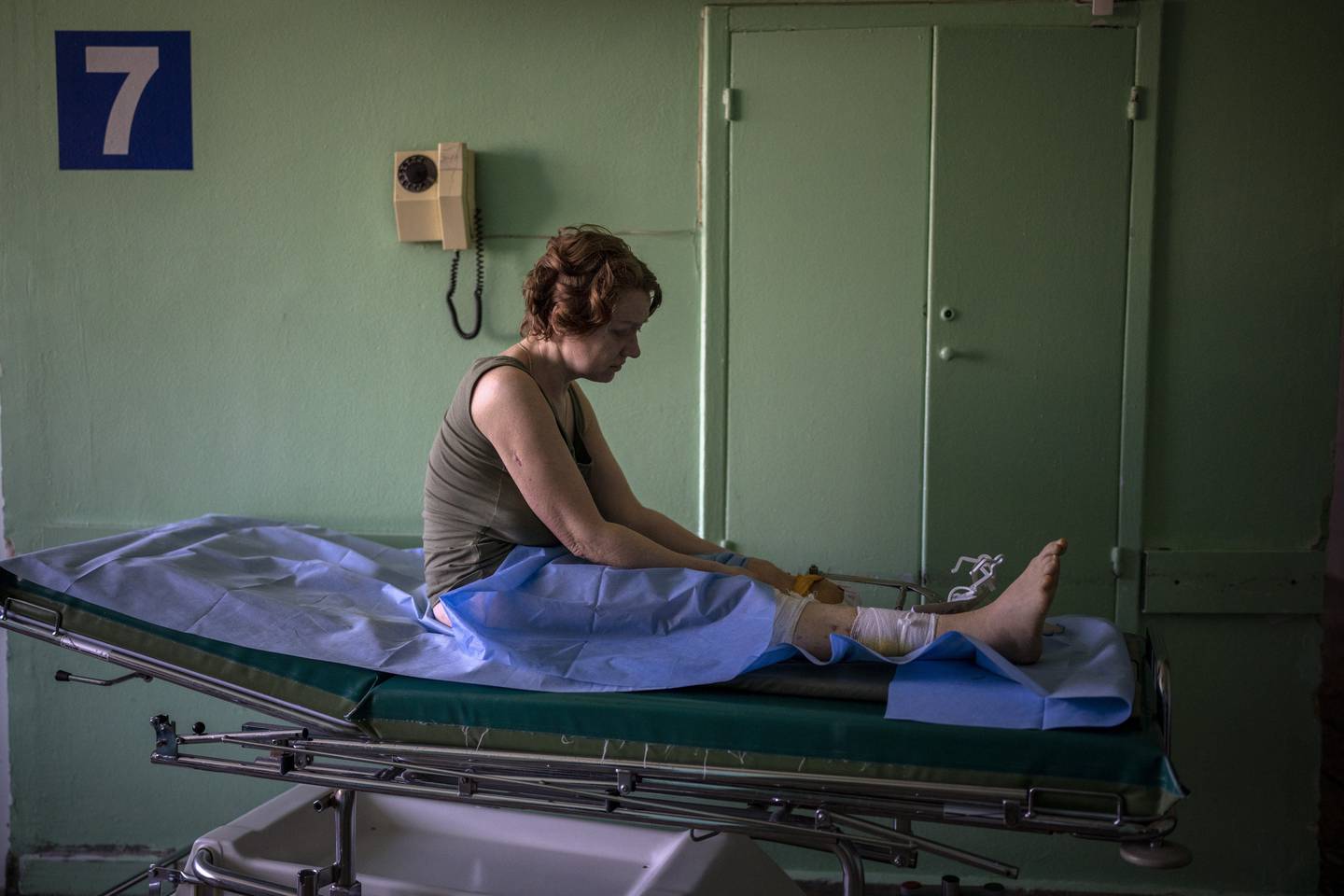 Olena Viter, 45, waits outside the operating theatre before a surgery, at a public hospital in Kyiv, Ukraine, Tuesday, May 10, 2022. Olena lost her leg and her 14-year-old son Ivan when bombs rained down on their village Rozvazhiv, in the Kyiv region, on March 14. Four people died, including Ivan, and about 20 were wounded. (AP Photo/Emilio Morenatti)