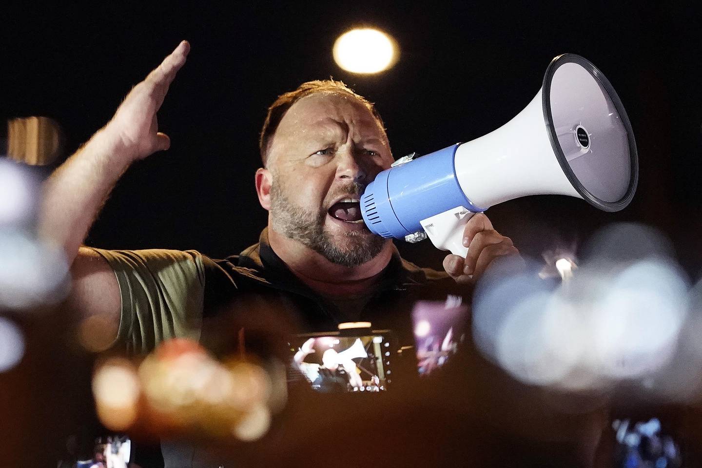 FILE - In this Nov. 5, 2020 file photo, radio host Alex Jones rallies pro Trump supporters outside the Maricopa County Recorder's Office, in Phoenix. The U.S. Supreme Court on Monday, April 5, 2021 declined to hear an appeal by the Infowars host and conspiracy theorist, who was fighting a Connecticut court sanction in a defamation lawsuit brought by relatives of some of the victims of the Sandy Hook Elementary School shooting. (AP Photo/Matt York, File)