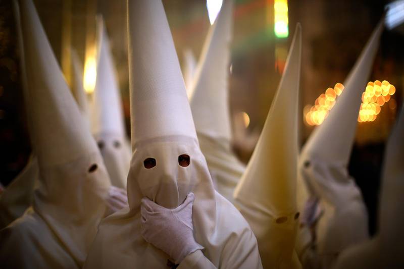 Hooded penitents from "La Borriquita" take part during a Holy Week procession in Cordoba, Spain, Sunday, April 9, 2017. Hundreds of processions take place throughout Spain during the Easter Holy Week. (AP Photo/Manu Fernandez)