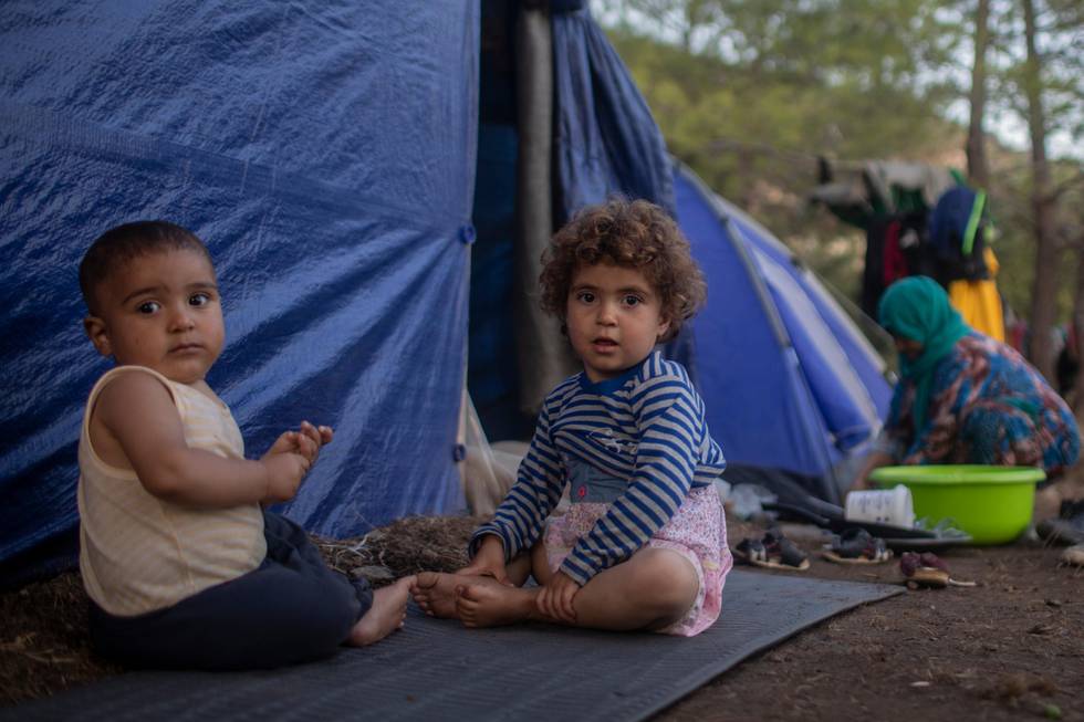 Syrians children play outside a makeshift tent near the refugee and migrant camp at the Greek island of Samos on Wednesday, Sept. 25, 2019. The refugee and migrant camp of Samos island hosts more than seven times its capacity. (AP Photo/ Petros Giannakouris)