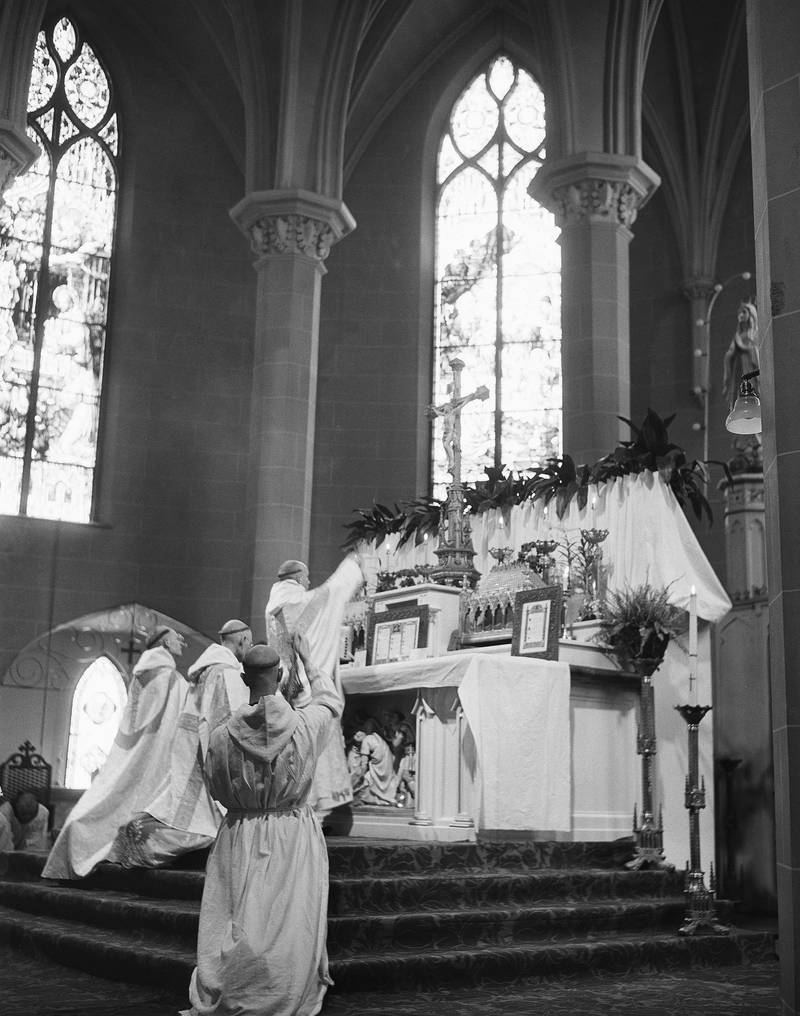 Father Louis (Thomas Merton) elevates the Chalice during his first reading of Solemn High Mass since his elevation, May 28, 1949 in Trappist, KY. In the foreground the Censor-Bearer swings his censor. At this point of the ceremony the consecration of the body and blood of Christ are complete and will be followed by the Communion. (AP Photo)