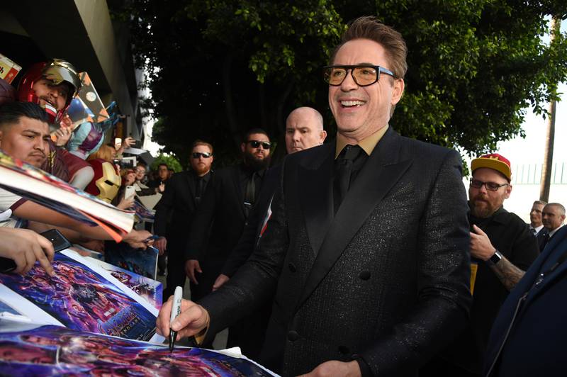 FILE - In this April 22, 2019, file photo Robert Downey Jr. signs autographs as he arrives at the premiere of "Avengers: Endgame" at the Los Angeles Convention Center. After playing Iron Man for more than a decade, Robert Downey Jr. has found a real-life villain he wants to defeat: pollution. The movie star says he plans to start an organization next year called the Footprint Coalition. (Photo by Chris Pizzello/Invision/AP, File)