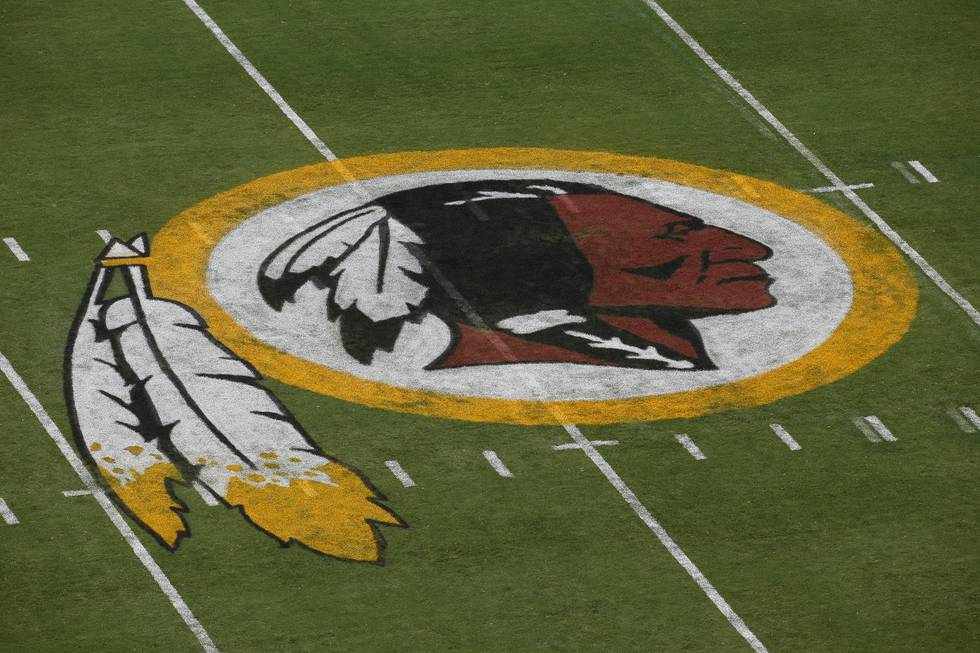 FILE - In this Aug. 7, 2014, file photo, the Washington Redskins logo is seen on the field before the team's NFL football preseason game against the New England Patriots in Landover, Md. Washingtons NFL team will get rid of the name "Redskins" on Monday, July 13, according to multiple reports. Its unclear when a new name will be revealed for one of the leagues oldest franchises. The team launched a "thorough review" of the name July 3. (AP Photo/Alex Brandon, File)