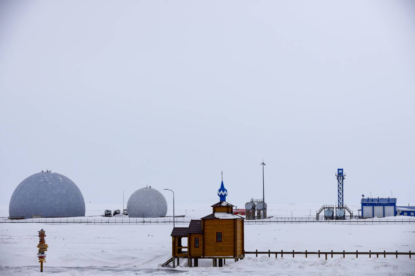 An Orthodox Church is seen with a radar facility in the background on the Alexandra Land island near Nagurskoye, Russia, Monday, May 17, 2021. Bristling with missiles and radar, Russia's northernmost military base projects the country's power and influence across the Arctic from a remote, desolate island amid an intensifying international competition for the region's vast resources. Russia's northernmost military outpost sits on the 80th parallel North, projecting power over wide swathes of Arctic amid an intensifying international rivalry over the polar region's vast resources. (AP Photo/Alexander Zemlianichenko)