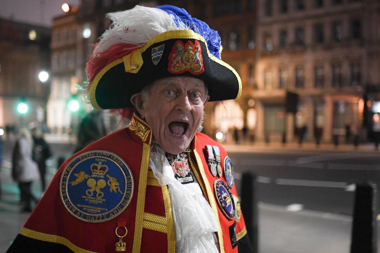 A town crier walks in London, Friday, Jan. 31, 2020. Britain officially leaves the European Union on Friday after a debilitating political period that has bitterly divided the nation since the 2016 Brexit referendum.(AP Photo/Alberto Pezzali)