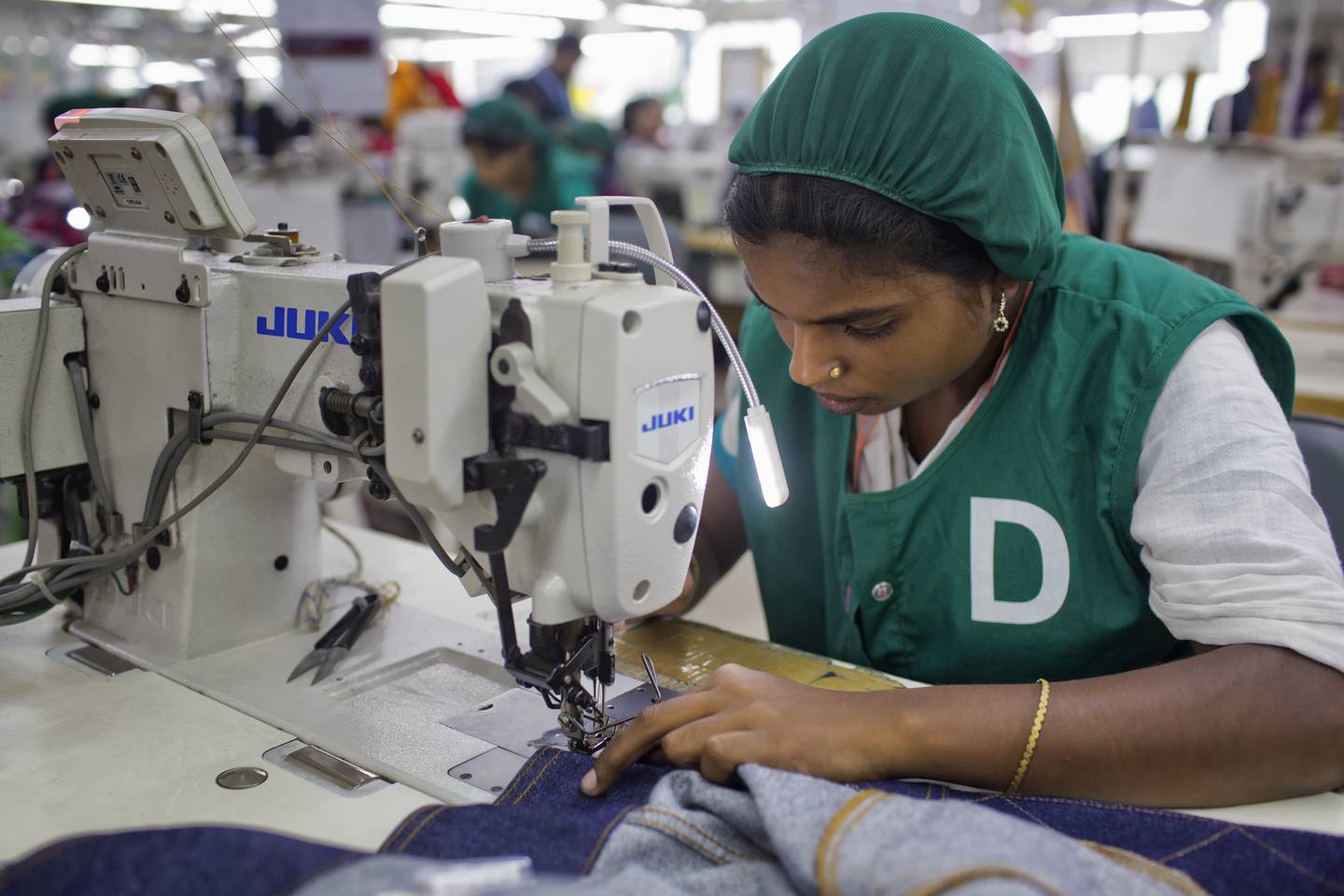 In this April 19, 2018 photo, Bangladeshi garment worker Ruma Akter, 25, who worked at the Rana Plaza garment factory that collapsed five years earlier, works at Snowtex garment factory in Dhamrai, near Dhaka, Bangladesh. A new survey says that five years after the factory building collapse in Bangladesh killed 1,134 people and left thousands injured some things have changed for the better for the workers who toiled in the country's huge garment industry but much remains to be done. The survey by the Center for Business and Human Rights at New York University's Stern School of Business found that the largest factories generally have complied with new safety standards set by foreign clothing brands since the 2013 accident. (AP Photo/A.M. Ahad)