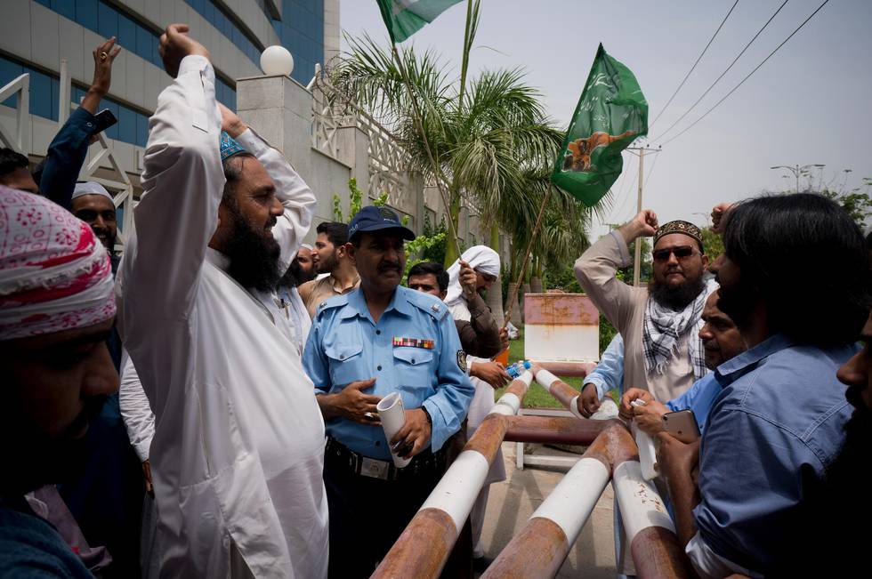 In this Monday, July 9, 2018 photo, supporters of Pakistani radical, religious and sectarian groups protest outside the office of the Pakistan Electronic Media Regulatory Authority, demanding that their election campaigns to be aired by media channels, in Islamabad, Pakistan. The country is seeing an unprecedented number of extremists and militant sectarian groups -- even an international terror figure with a $10 million U.S.-offered bounty on his head -- on the campaign bandwagon ahead of parliamentary elections later this month. (AP Photo/B.K. Bangash)