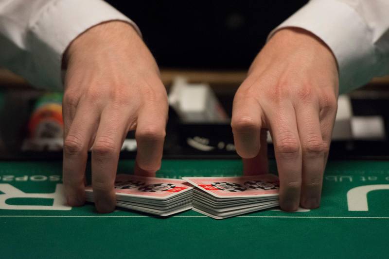 In this photo taken Saturday, July 9, 2016, a dealer shuffles cards during Day 1A of the Main Event of the World Series of Poker at the Rio Convention Center in Las Vegas. (Jason Ogulnik/Las Vegas Review-Journal via AP) 