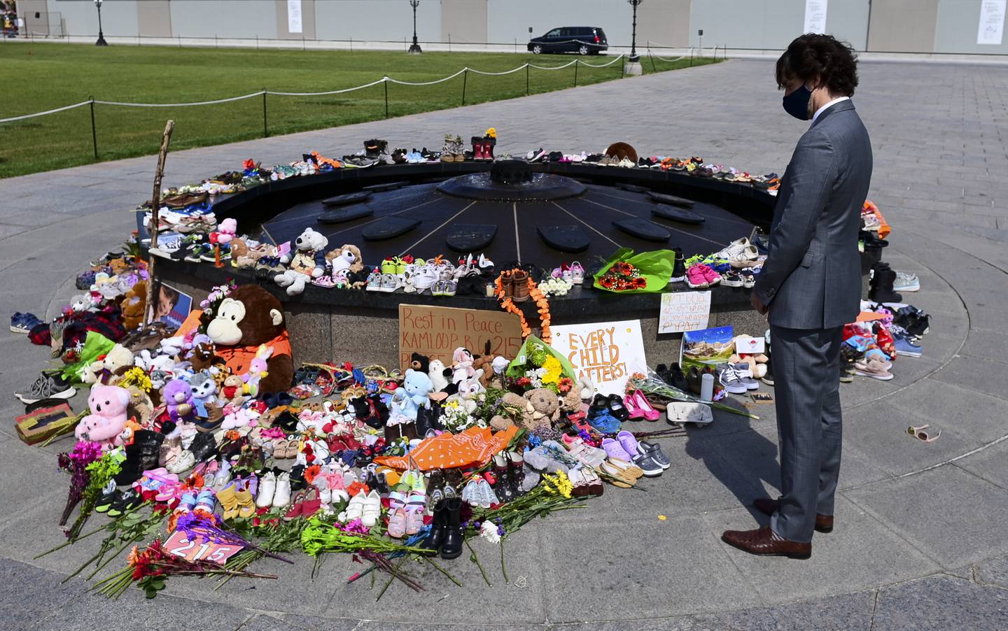 Canadas statsminister Justin Trudeau la tirsdag ned blomster til minne om de mange døde barna som er funnet i en massegrav ved en internatskole for urfolksbarn. Foto: AP / NTB
