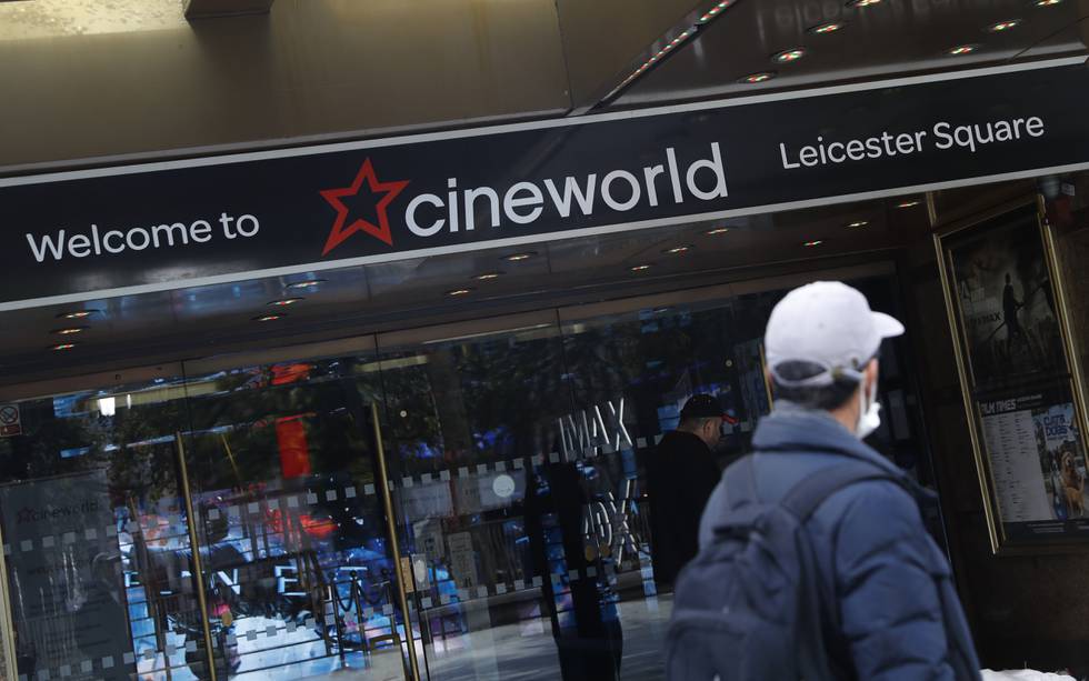 A man walks past a Cineworld cinema in Leicester Square, London, Monday, Oct. 5, 2020. The company Cineworld have confirmed that all the 127 UK cineworld cinemas will temporarily close, affecting some 5,500 employees, this is due to the ongoing coronavirus pandemic and the lack of movies at are being released. (AP Photo/Alastair Grant)