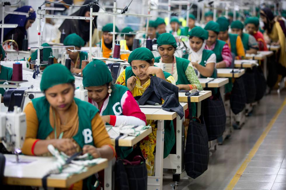 FILE - In this April 19, 2018 file photo, trainees work at Snowtex garment factory in Dhamrai, near Dhaka, Bangladesh. A survey of factory owners in Bangladesh has found that major fashion retailers that are closing shops and laying off workers in Europe and the U.S. also are canceling their sometimes already completed orders, as workers often go unpaid. A report released Friday, March 27, 2020, by Mark Anner, director of the Center of Global Rights, found the coronavirus crisis has resulted in millions of factory workers being sent home without the wages or severance they are owed.  About 4.1 million people work in apparel factories in Bangladesh, the world's No. 2 garment exporter after China. (AP Photo/A.M. Ahad, File)