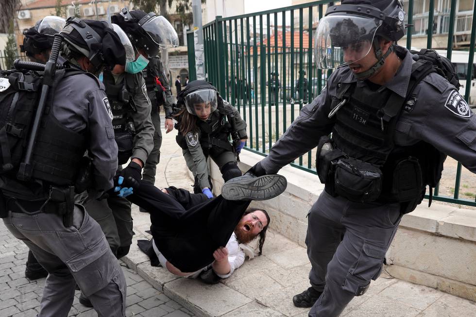 File - In this Monday, March 30, 2020 file photo, Israeli police arrest an Ultra Orthodox Jew during protest against government's measures to stop the spread of the coronavirus in the orthodox neighborhood of Mea Shearim in Jerusalem. (AP Photo/Mahmoud Illean, File)