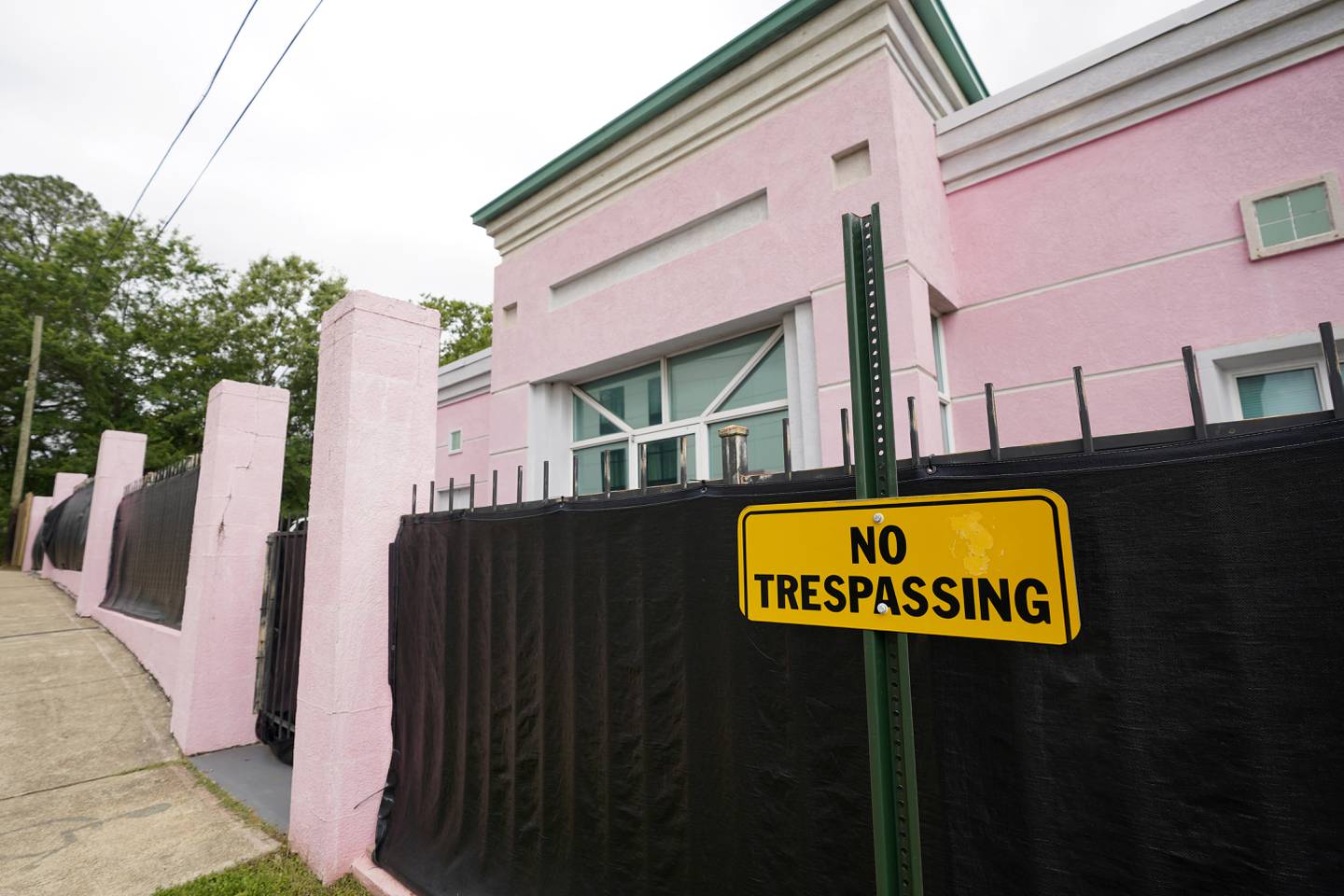 FILE - In this May 19, 2021, file photo, the Jackson Women's Health Organization clinic, more commonly known as "The Pink House," is shrouded with a black tarp so that its clients may enter in privacy in Jackson, Miss. The Mississippi attorney general’s office is expected to file briefs with the U.S. Supreme Court on Thursday to outline the state’s arguments in a case that could upend nearly 50 years of court rulings on abortion rights nationwide. (AP Photo/Rogelio V. Solis, File)