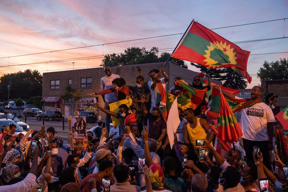 Members of the Oromo community stop during a protest on University Avenue in St. Paul, Minn., to sing a song by Hachalu Hundessa, Wednesday, July 1, 2020. Protesters apparently outraged by the killing of Hachalu Hundessa, a popular singer in Ethiopia, stopped traffic on an interstate during the evening rush hour, before leaving the highway and walking along surface roads. (Evan Frost/Minnesota Public Radio via AP)