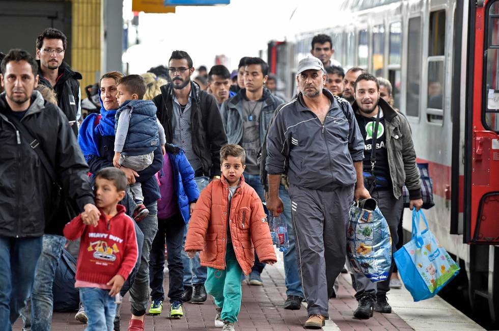 Refugees from Syria arrive at the train station  in Dortmund, Germany, Sunday, Sept. 6, 2015. Thousands of migrants and refugees arrived in Dortmund by trains. (AP Photo/Martin Meissner)