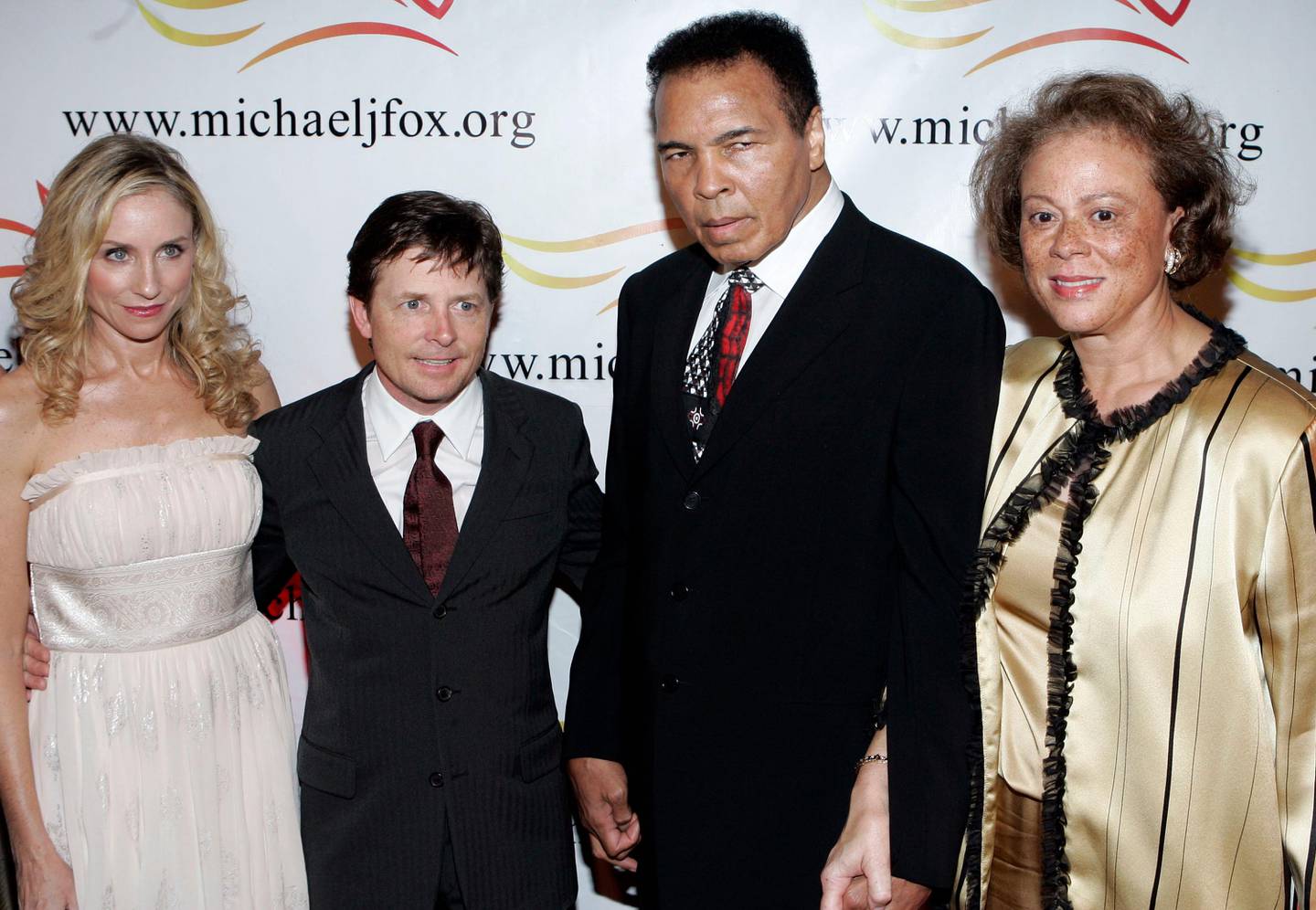 Actress Tracy Pollan, left, her husband Michael J. Fox, second left, boxing legend Muhammad Ali and his wife Lonnie Ali, right, attend the Michael J. Fox Foundation's "A Funny Thing Happened On The Way To Cure Parkinson's..." benefit gala, Saturday, Nov. 11, 2006, in New York. (AP Photo/Stephen Chernin)