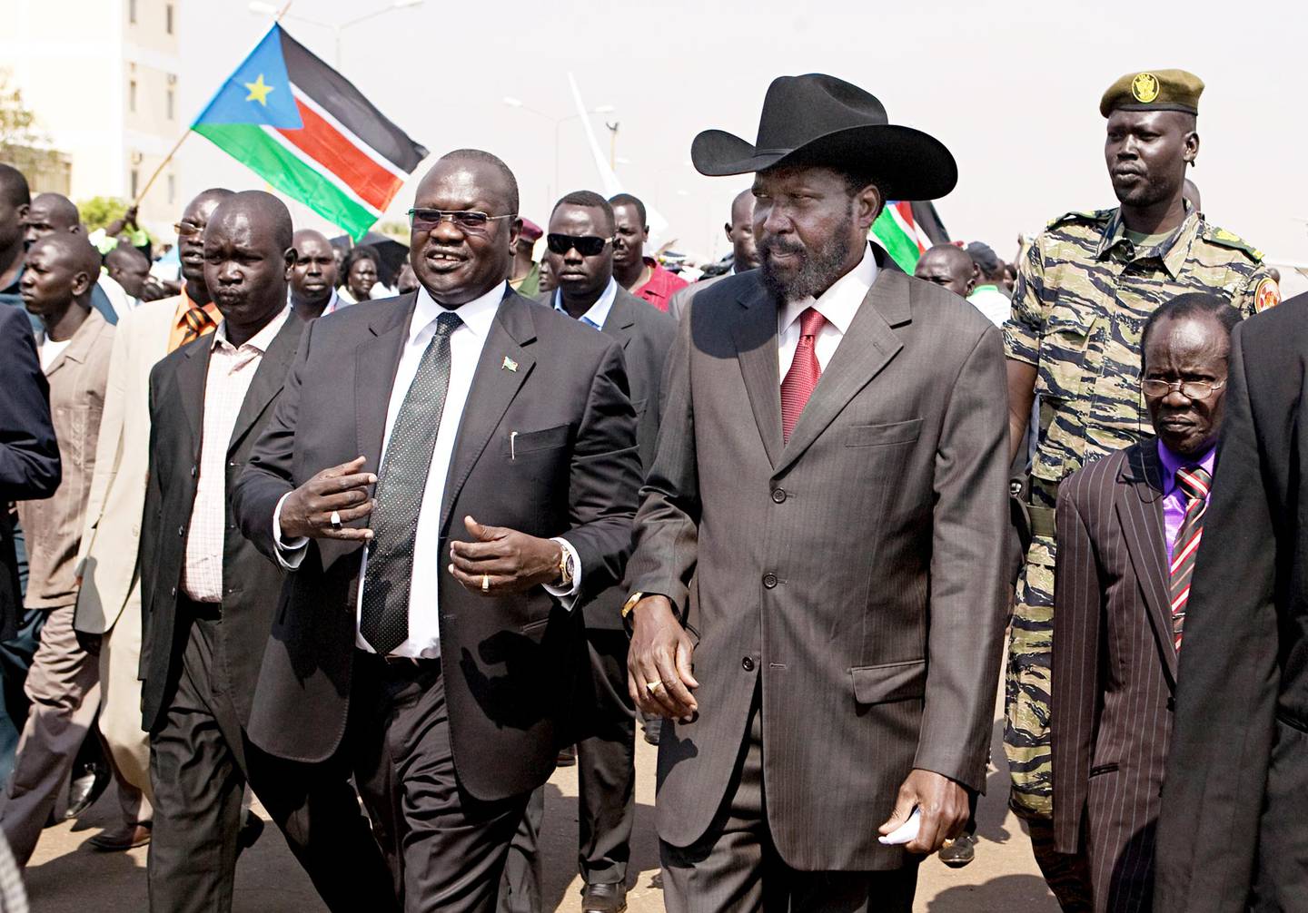 FILE - In this Tuesday, Feb. 8, 2011 file photo, South Sudanese President Salva Kiir, centre-right, is greeted by then Vice-President Riek Machar, centre-left, on Kiir's return to Juba, South Sudan, from Khartoum where he attended the formal announcement of southern Sudan's referendum results. South Sudan President Salva Kiir signed a peace deal with rebels Wednesday, Aug. 26, 2015 in a ceremony witnessed by regional leaders in the capital Juba, after 20 months since the start of fighting between loyalist forces and rebels led by his former deputy Riek Machar. (AP Photo/Pete Muller, File)